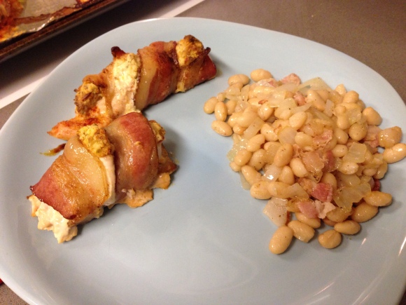 Cream cheese-stuffed, bacon-wrapped chicken served with beans, bacon and onion